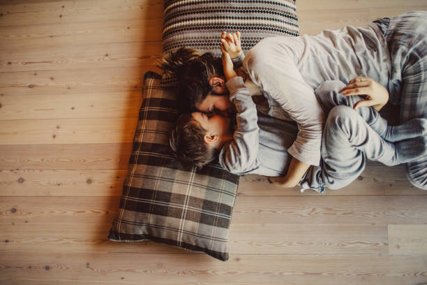 Loving mom tickling her kid on flooring | Birons Flooring Inc