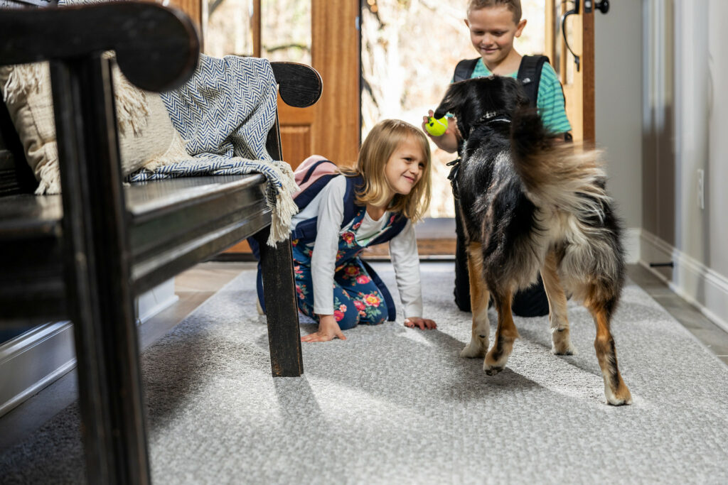 Kids playing with dog on carpet floors | Birons Flooring Inc
